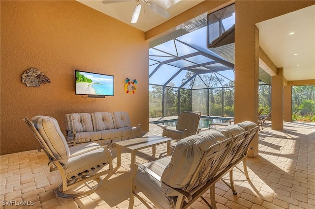 view of patio with a pool, ceiling fan, glass enclosure, and outdoor lounge area