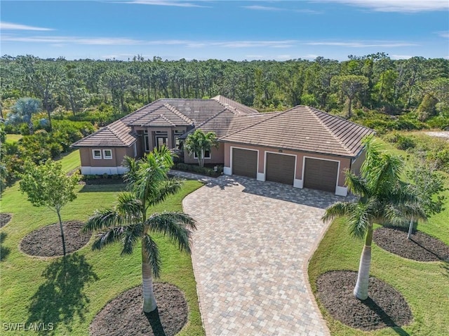 ranch-style home featuring a front yard and a garage