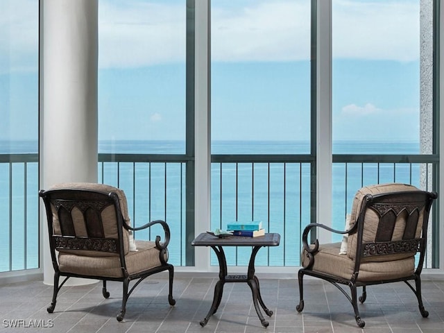 sunroom / solarium featuring a water view