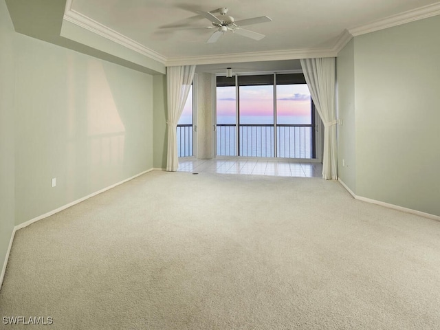 spare room featuring crown molding, light colored carpet, and ceiling fan