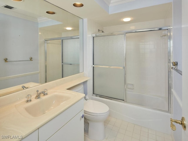 full bathroom featuring crown molding, enclosed tub / shower combo, vanity, tile patterned floors, and toilet