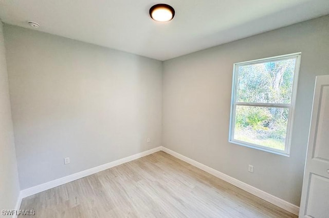 spare room with plenty of natural light and light wood-type flooring