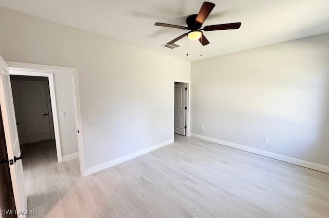 spare room featuring ceiling fan and light wood-type flooring