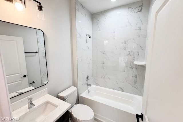 full bathroom with vanity, toilet, and tiled shower / bath