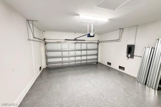 garage with electric panel and a garage door opener