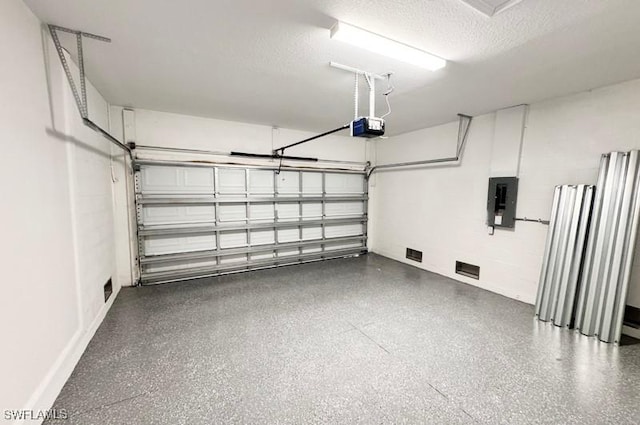 garage with electric panel and a garage door opener