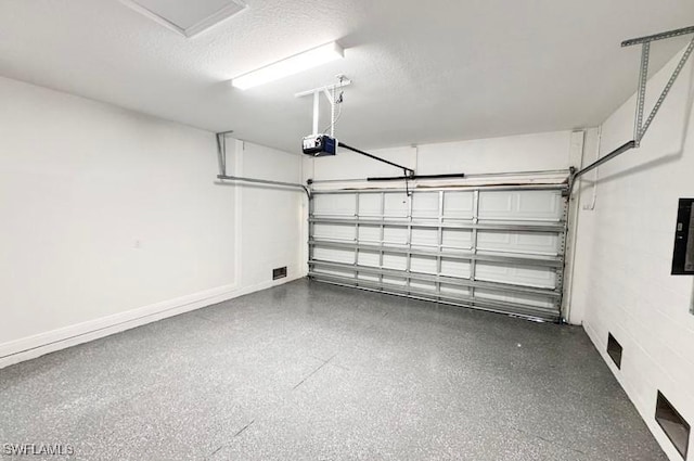 garage featuring electric panel and a garage door opener