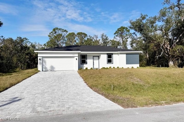 ranch-style home featuring a front lawn and a garage