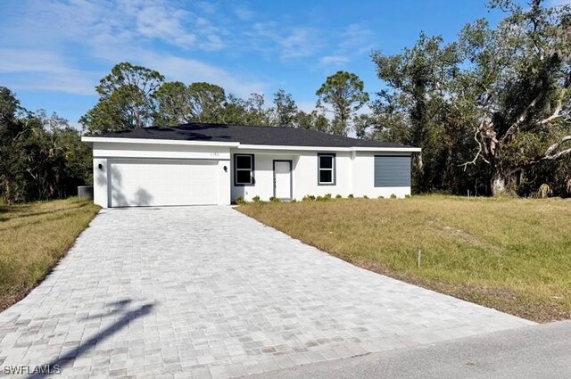 single story home featuring a front yard and a garage