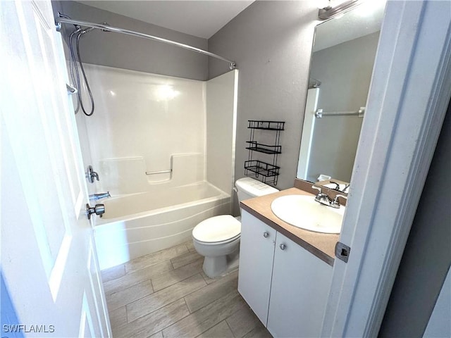 full bathroom with hardwood / wood-style flooring, vanity, toilet, and bathtub / shower combination