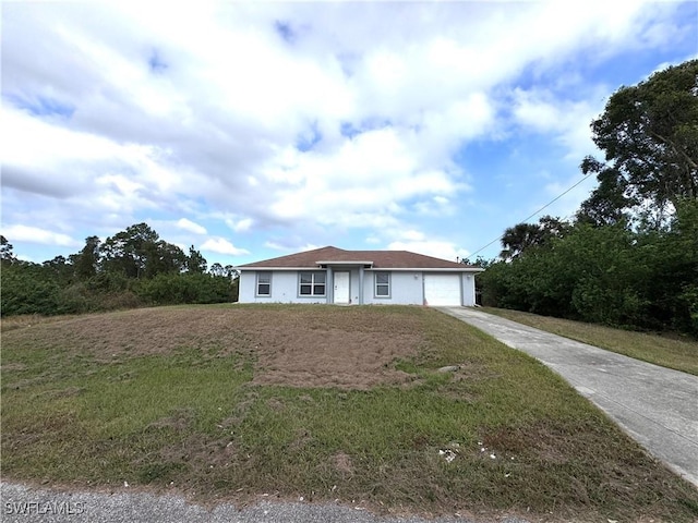 view of front of house featuring a garage and a front yard