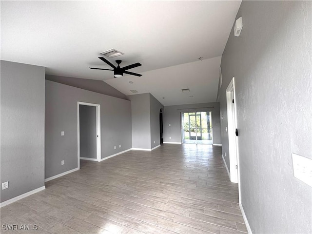 unfurnished room with ceiling fan, light hardwood / wood-style floors, and vaulted ceiling