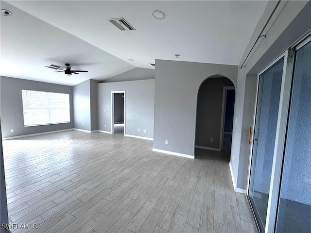 spare room with ceiling fan, light hardwood / wood-style floors, and vaulted ceiling