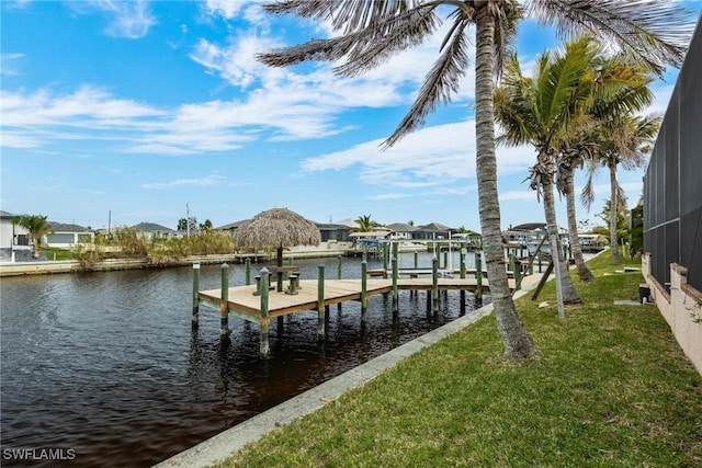 view of dock with a lawn, a lanai, and a water view