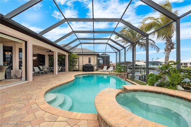 view of pool featuring a water view, a lanai, a patio, and an in ground hot tub