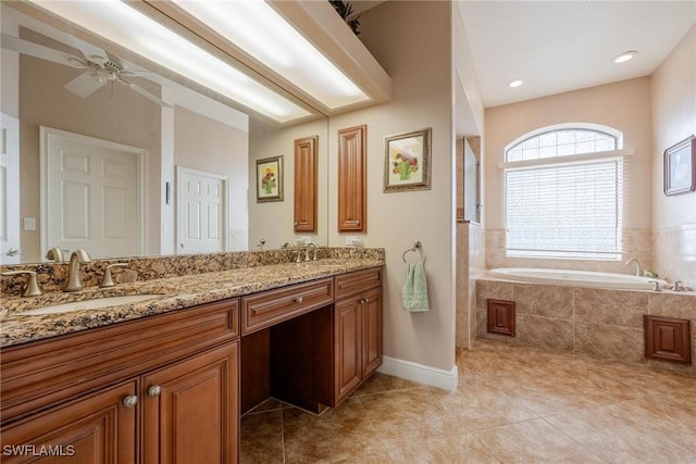 bathroom with vanity, tile patterned floors, ceiling fan, and tiled tub