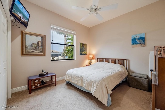 carpeted bedroom featuring ceiling fan and a closet