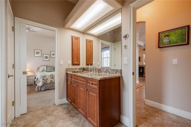 bathroom featuring tile patterned floors, ceiling fan, and vanity