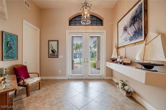 doorway to outside with light tile patterned flooring and french doors