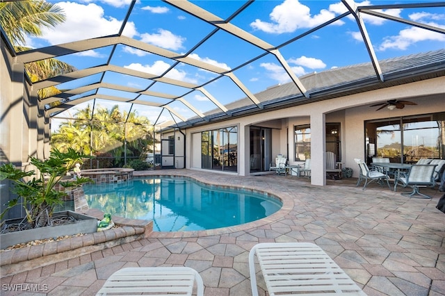 view of pool with an in ground hot tub, a patio, ceiling fan, and a lanai