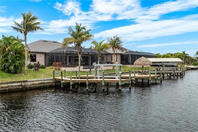 dock area with a lanai and a water view