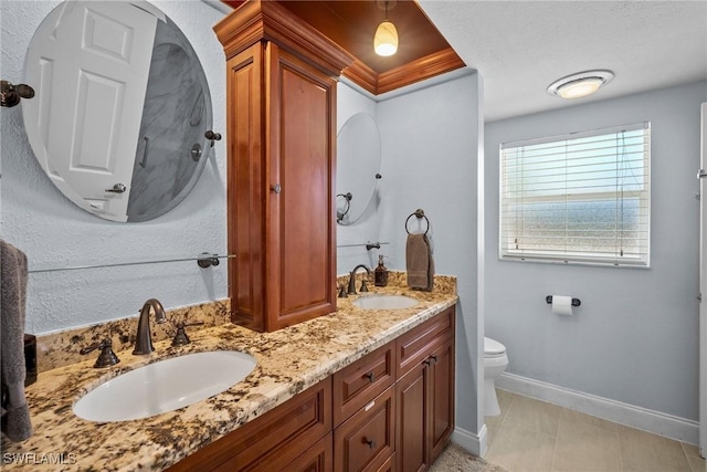 bathroom with tile patterned floors, vanity, toilet, and a textured ceiling