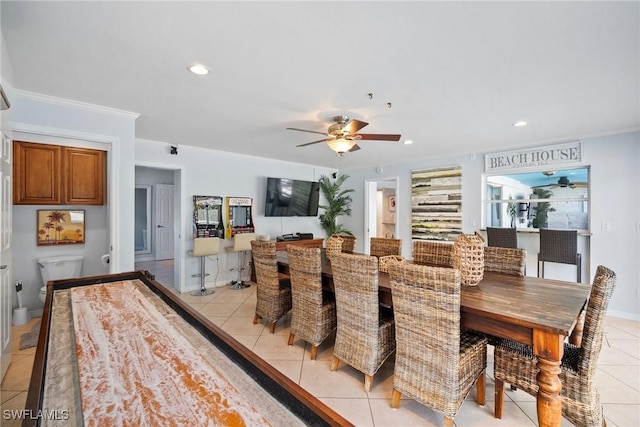 dining area with ceiling fan, light tile patterned flooring, and ornamental molding