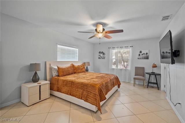 tiled bedroom featuring ceiling fan