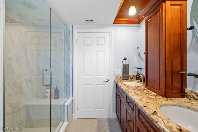 bathroom featuring vanity and a shower with shower door