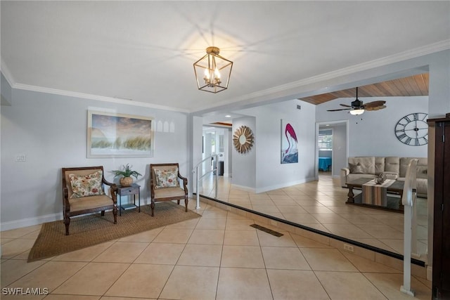 living area with ceiling fan with notable chandelier, crown molding, and light tile patterned flooring