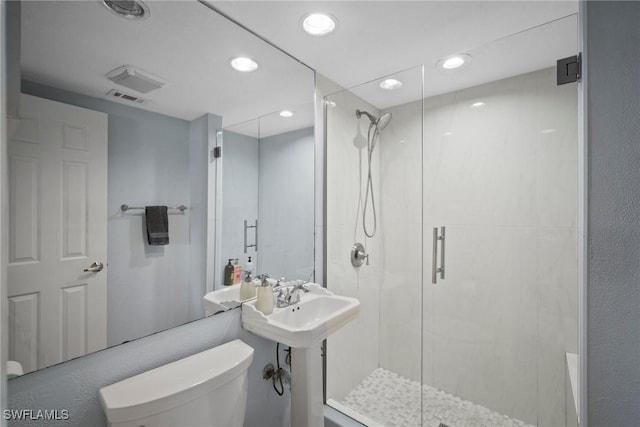 bathroom featuring toilet and walk in shower