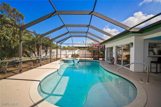 view of swimming pool with a patio area, a lanai, and an in ground hot tub