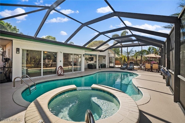 view of pool featuring glass enclosure, a patio area, and an in ground hot tub