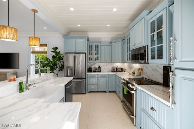 kitchen featuring pendant lighting, sink, light stone countertops, tasteful backsplash, and stainless steel appliances