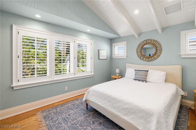 bedroom featuring vaulted ceiling with beams and dark wood-type flooring