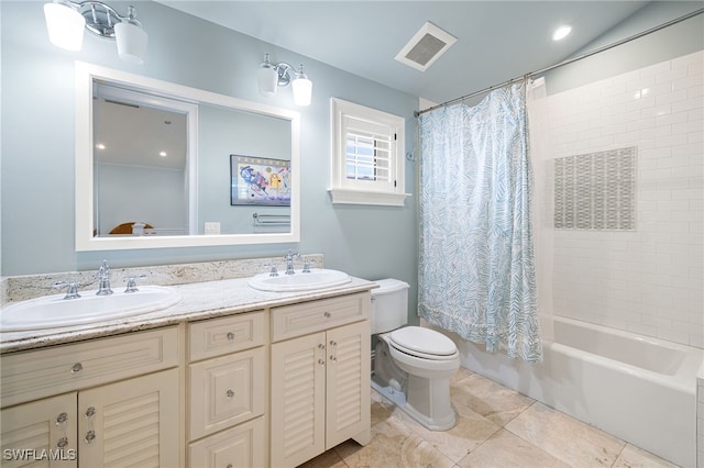 full bathroom with vanity, shower / bath combo, and toilet