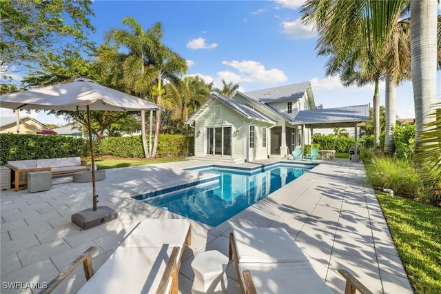 view of swimming pool with outdoor lounge area and a patio