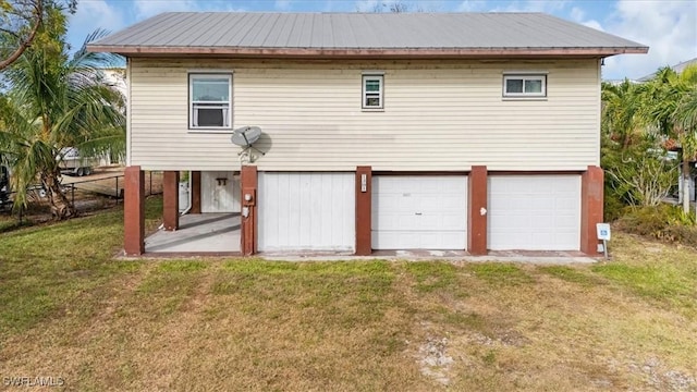 1291 Chokoloskee Dr, Chokoloskee, FL 34138 - back of house with a lawn and a garage
