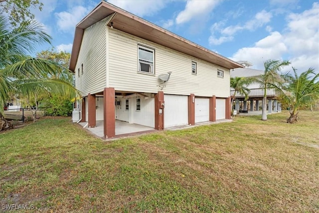 1291 Chokoloskee Dr, Chokoloskee, FL 34138 - back of property with a garage and a yard