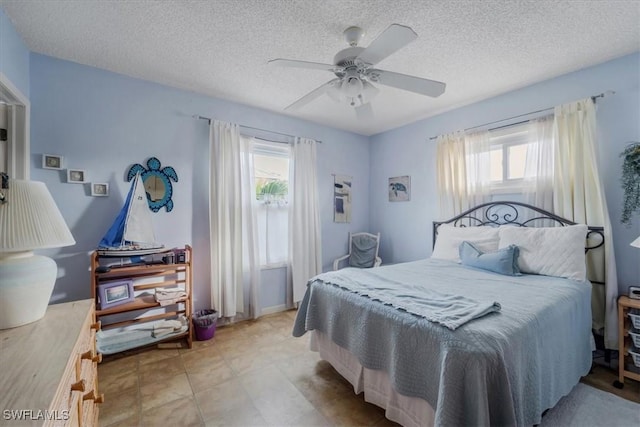 1291 Chokoloskee Dr, Chokoloskee, FL 34138 - bedroom featuring ceiling fan, a textured ceiling, and multiple windows