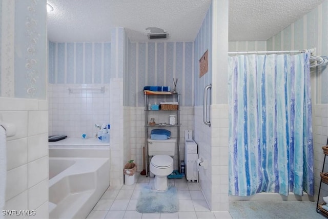 1291 Chokoloskee Dr, Chokoloskee, FL 34138 - bathroom with tile patterned flooring, tile walls, and a textured ceiling