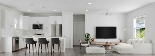 kitchen featuring white cabinetry, a center island, and stainless steel appliances