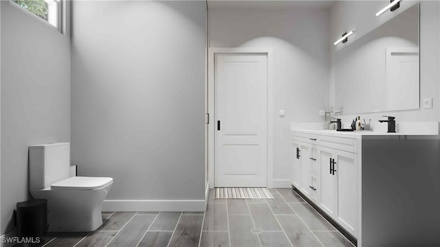 bathroom featuring hardwood / wood-style floors, vanity, and toilet