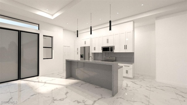 kitchen with white cabinets, a kitchen island with sink, appliances with stainless steel finishes, and tasteful backsplash