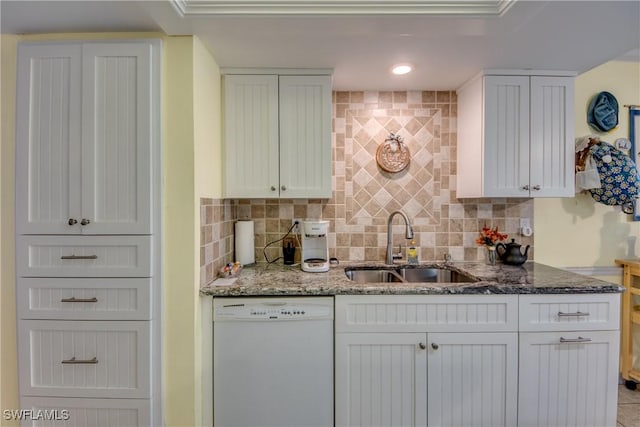 kitchen featuring decorative backsplash, dishwasher, white cabinets, and sink