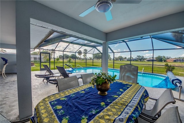 view of patio / terrace featuring ceiling fan and a lanai