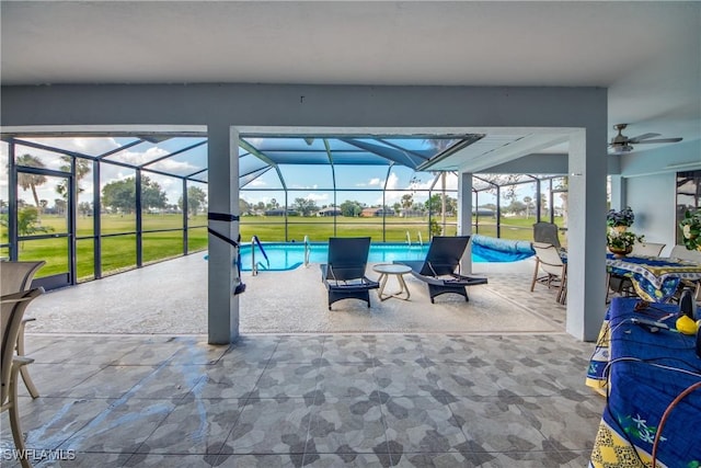 view of patio with glass enclosure and ceiling fan