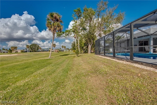 view of yard with glass enclosure