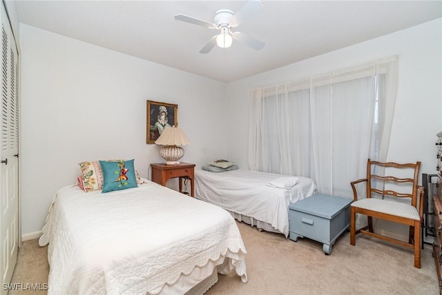 bedroom featuring ceiling fan and light colored carpet