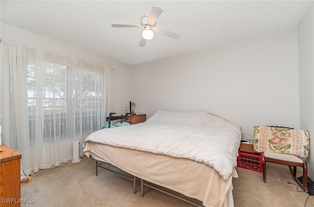 bedroom featuring ceiling fan and light colored carpet